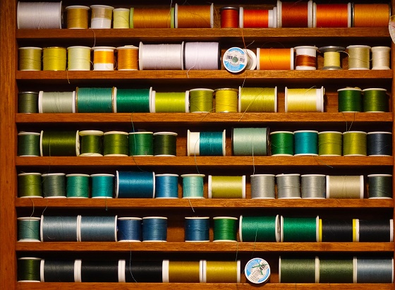A shelf of different coloured threads